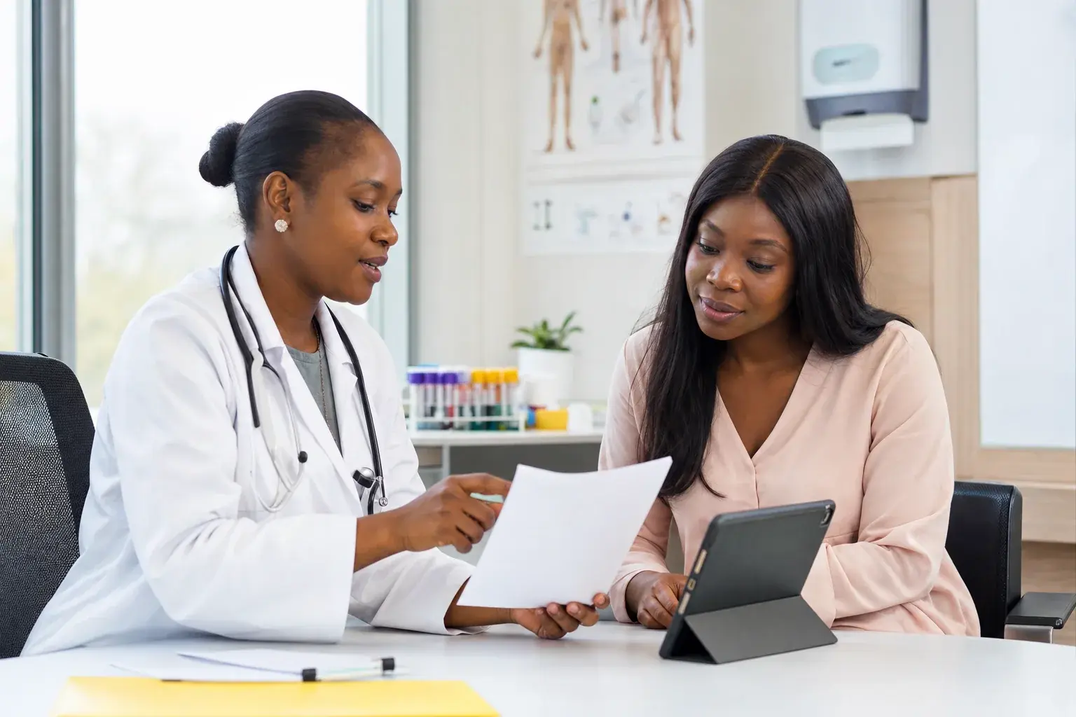 Nigerian clinician reviewing laboratory results and a continued care plan with a patient