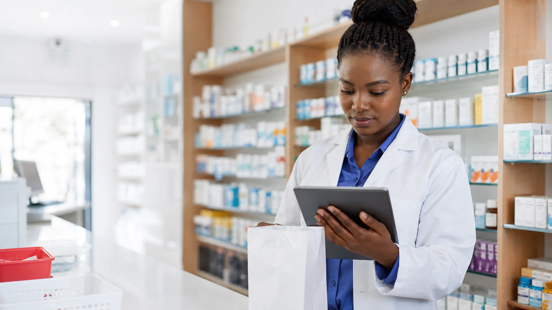 Nigerian pharmacist reviewing a digital prescription responsibly