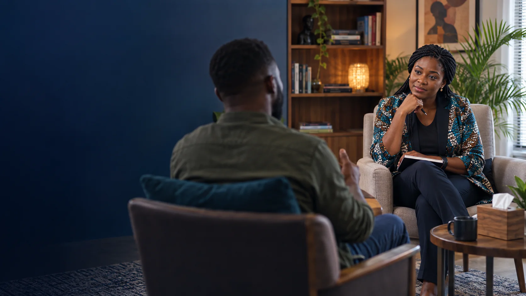 Black therapist listening attentively during a private counselling session